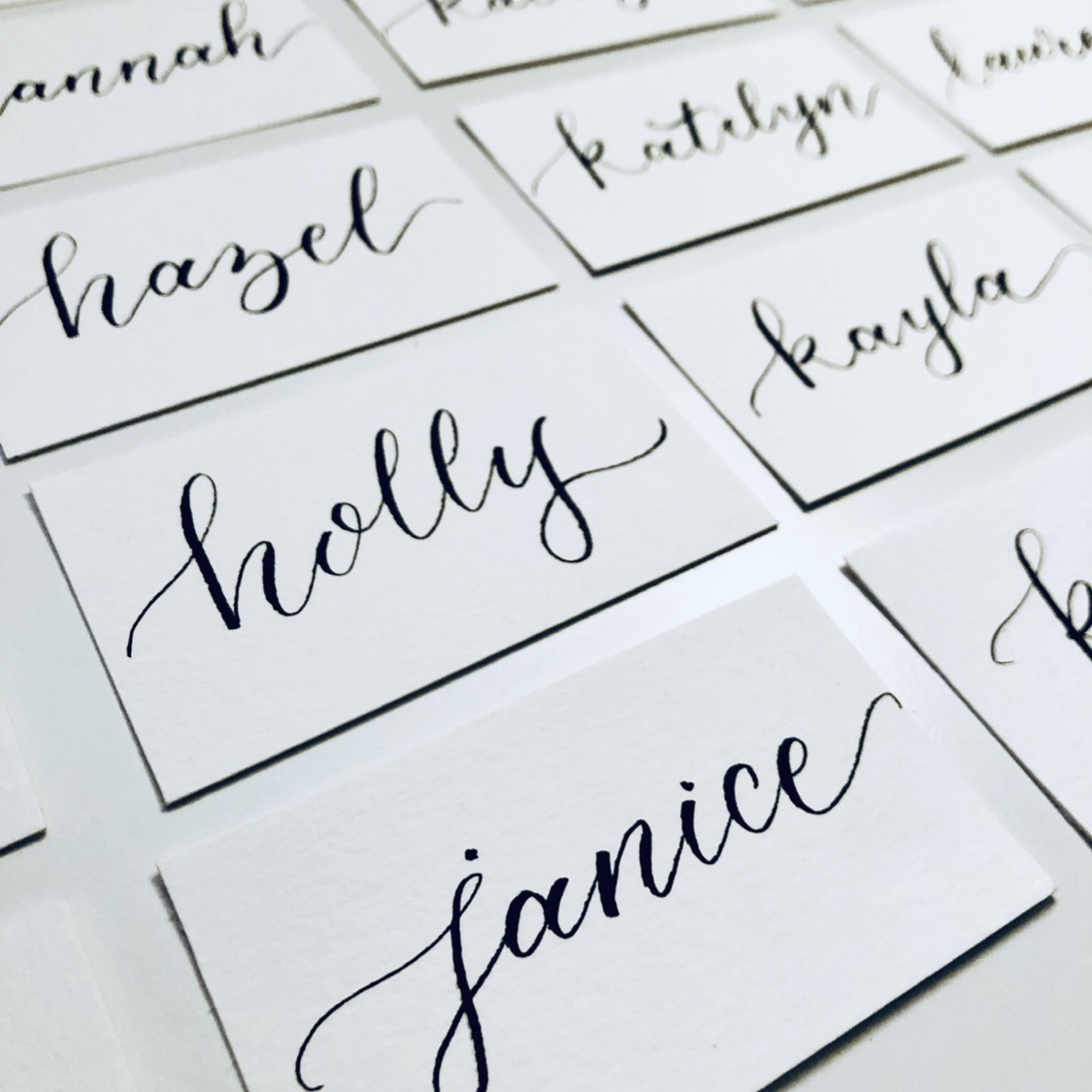 black ink calligraphy names on white paper